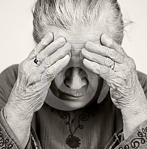 Sad old senior woman with health problems