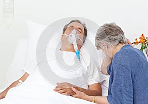 Sad old woman with her husband in a hospital