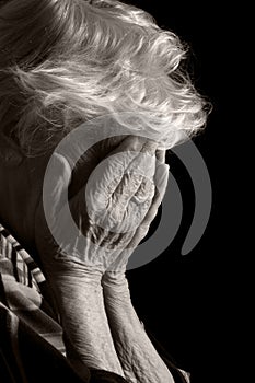 Sad Old Women with her hands to her face is dismay photo