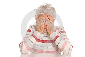 Sad Old Women with her hands to her face is dismay photo