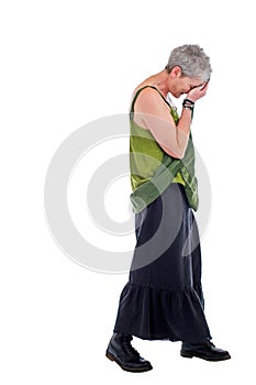 Sad older woman stands with head down