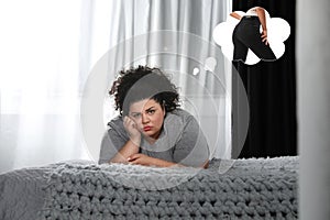 Sad overweight woman dreaming about slim body