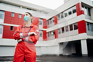 Sad overworked paramedic in uniform  in front of isolation hospital facility.Emergency room doctor in fear and psychological