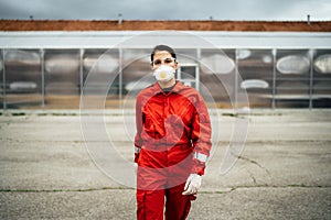 Sad overworked paramedic in uniform in front of isolation hospital facility.Emergency room doctor in fear and psychological stress