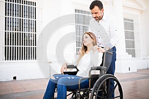 Sad paralyzed woman on a wheelchair photo