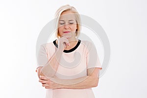 Sad pensive middle-aged woman posing on a white background, menopause health concept