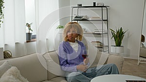 Sad pensive thinking worry sadness upset alone African American relaxed woman girl lonely female at home couch sofa with