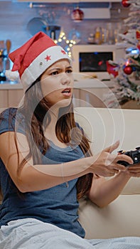 Sad person playing video games with controller on console