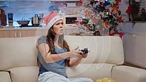 Sad person playing video games with controller on console