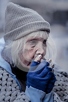 Sad poor woman being outside in winter