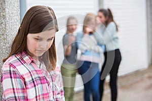 Sad Pre Teen Girl Feeling Left Out By Friends photo