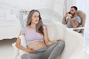 Sad pregnant woman taking offense