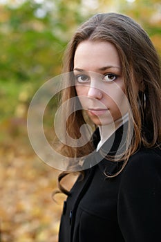 Sad pretty girl in fall park