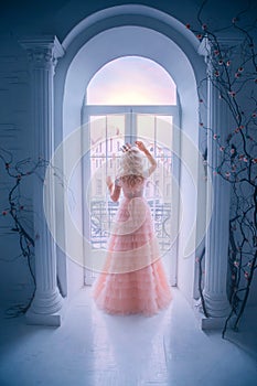 Sad princess looking window staying home. Queen lady enjoy evening sunset. concept freedom. long blonde hair.