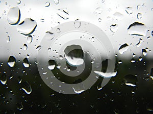 Sad rain drops on the window in black and white