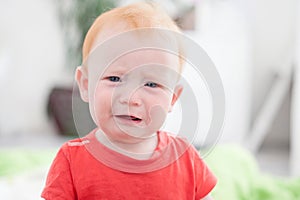 Sad redhead boy cries