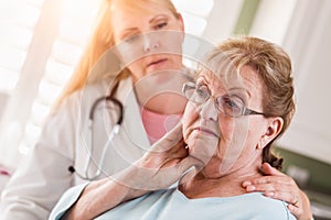 Sad Senior Adult Woman Being Consoled by Female Doctor or Nurse