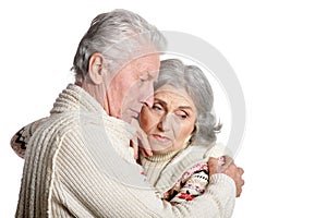 Sad senior couple hugging isolated on white background