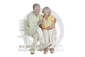 Sad senior couple sitting on bench