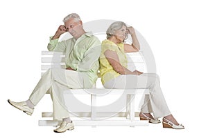 Sad senior couple sitting on bench