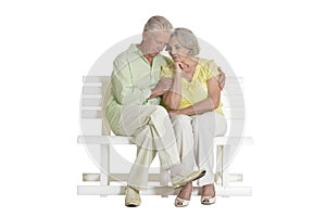 Sad senior couple sitting on bench