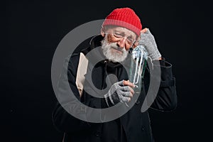 Sad senior homeless man with bottle of alcohol