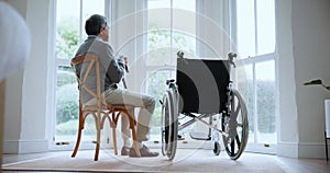 Sad, senior man and death of wife in home with wheelchair, window and memory of sitting together in living room. Elderly