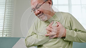 Sad senior man feeling bad pain use hand touching chest having heart attack
