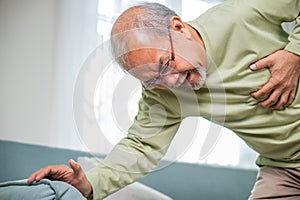 Sad senior man feeling bad pain use hand touching chest having heart attack