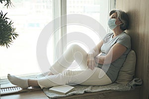 Sad sick elderly woman wearing mask despairing worried about medical issue injury, fearful of disease,