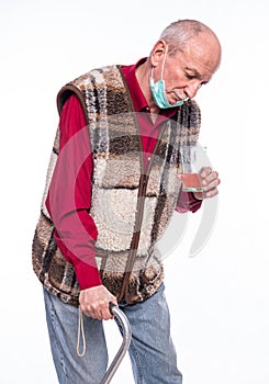 Sad sick senior man taking a dietary supplement over white background