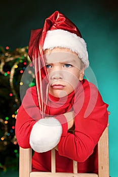 Sad small boy in santa hat