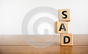 SAD, social anxiety disorder symbol. Concept words `SAD, social anxiety disorder` on cubes on a beautiful white background.