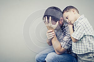 Sad son hugging his dad