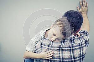 Sad son hugging his dad