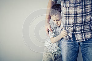 Sad son hugging his dad