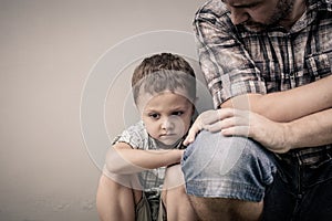 Sad son hugging his dad