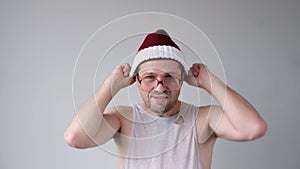 The sad and sorrowful European young man in a New Year's hat looks gloomily into the camera.