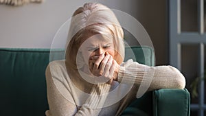 Sad stressed middle aged woman widow mourning crying at home photo