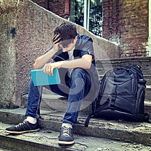 Sad Student with the Book