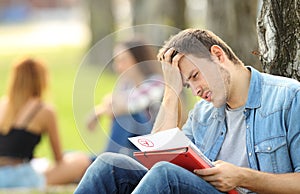 Sad student checking a failed exam photo