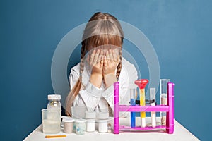Sad student child with science experiment