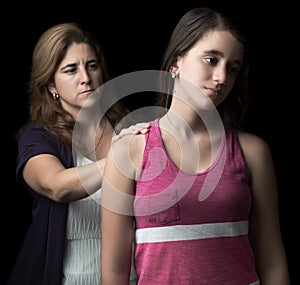 Sad teen girl with her mother offering help