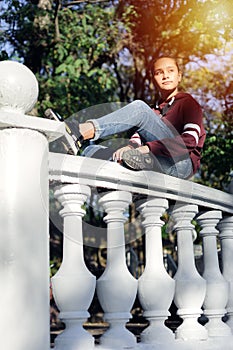 Sad teen girl is sad in the park.