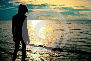 Sad teen girl standing on the beach