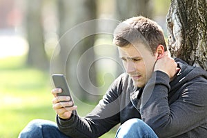 Sad teen reading phone messages