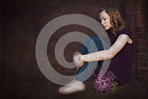 Sad teen with violet bouquet