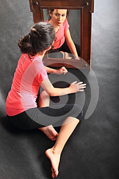 Sad teenage girl mirroring in mirror