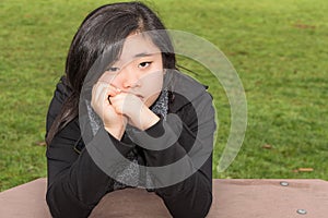 Sad Teenage Girl in Park