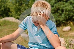 Sad teenager against the background of the nature. Close up